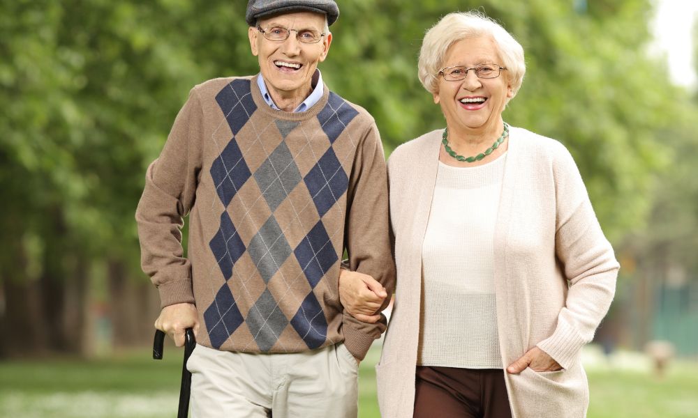 Two elderly people supporting each other