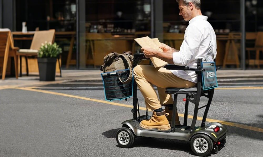 Man reading newspaper on portable scooter