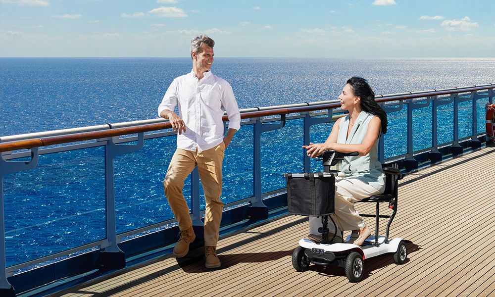 Lady driving a light mobility scooter to the beach