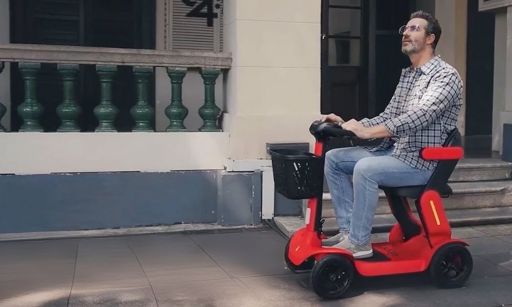 Man driving a 4-wheeled scooter for the elderly